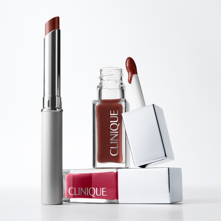 Selection of new brow and eye products dynamically placed on a glass shelf, in a brightly lit studio setting