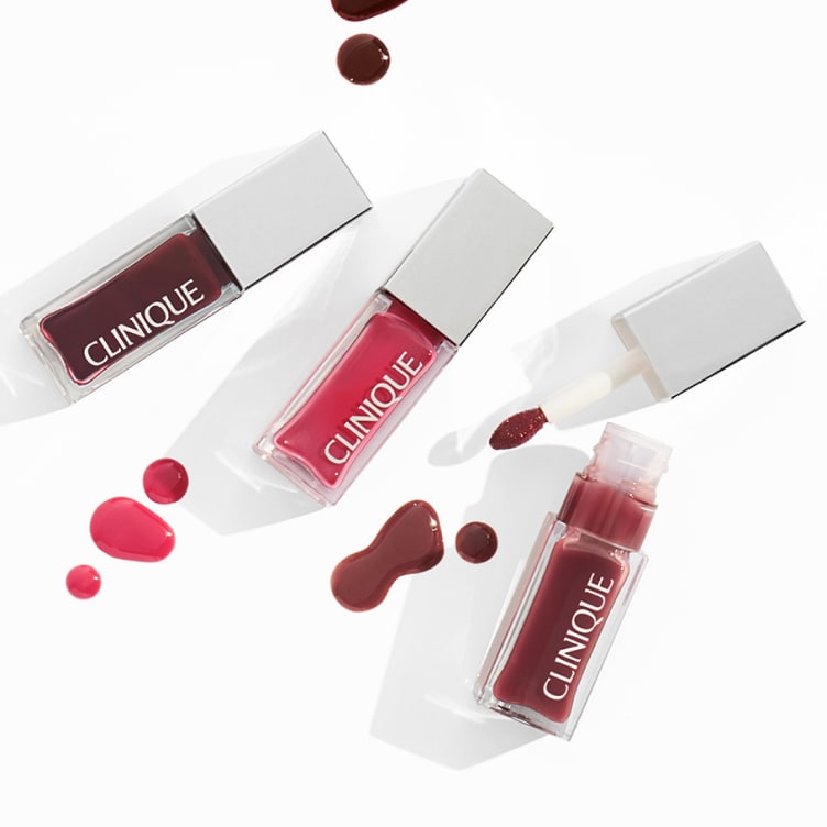 Selection of new brow and eye products dynamically placed on a glass shelf, in a brightly lit studio setting