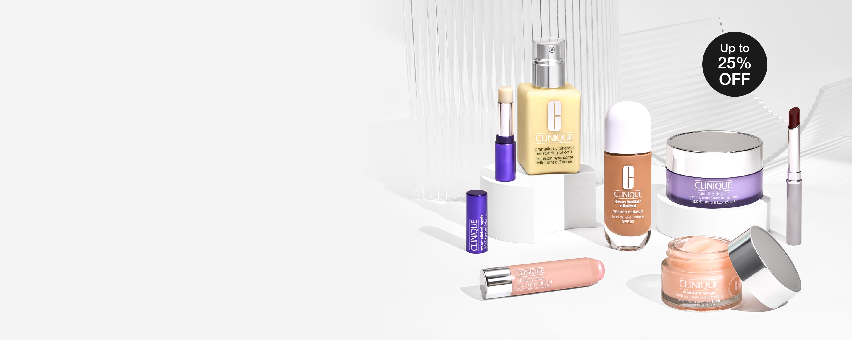 Selection of bestselling Clinique products in a brightly lit setting, on an array of grey plinths